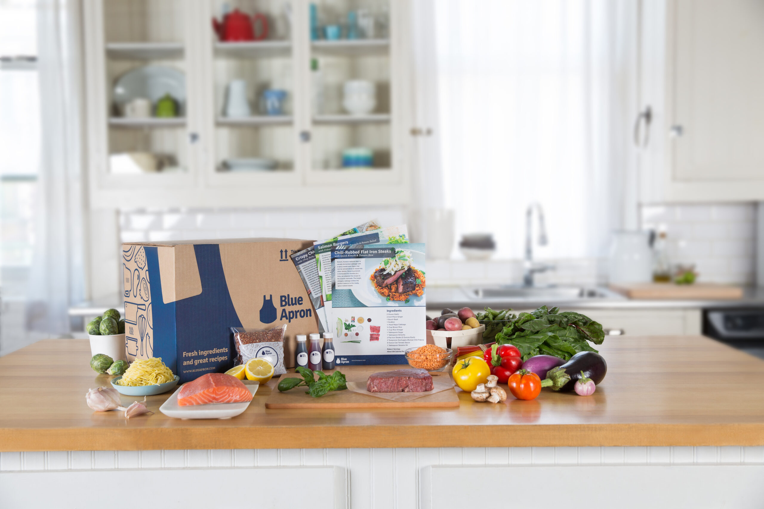 Blue Apron meal kit shown as an example of ingredients delivered for home cooking.