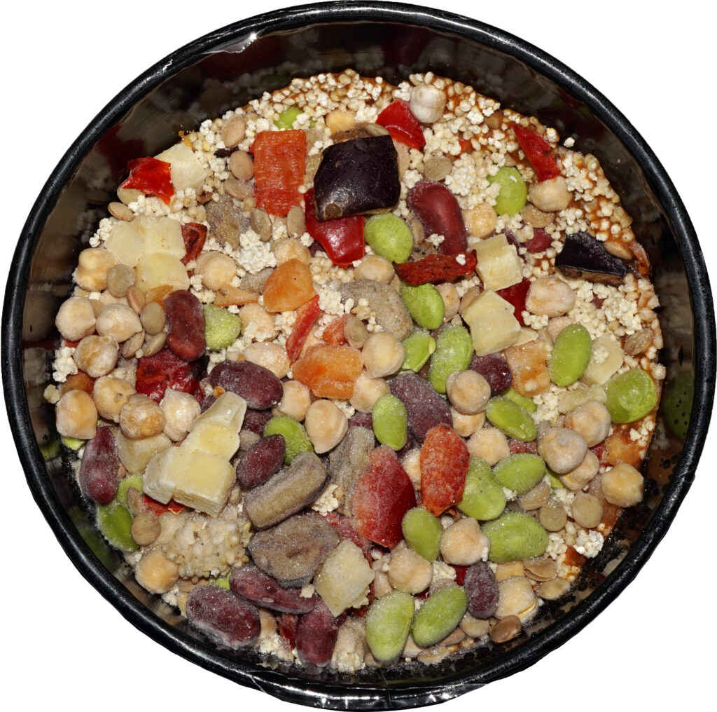 Prepared chickpea, bean and lentil stew in a food tray.